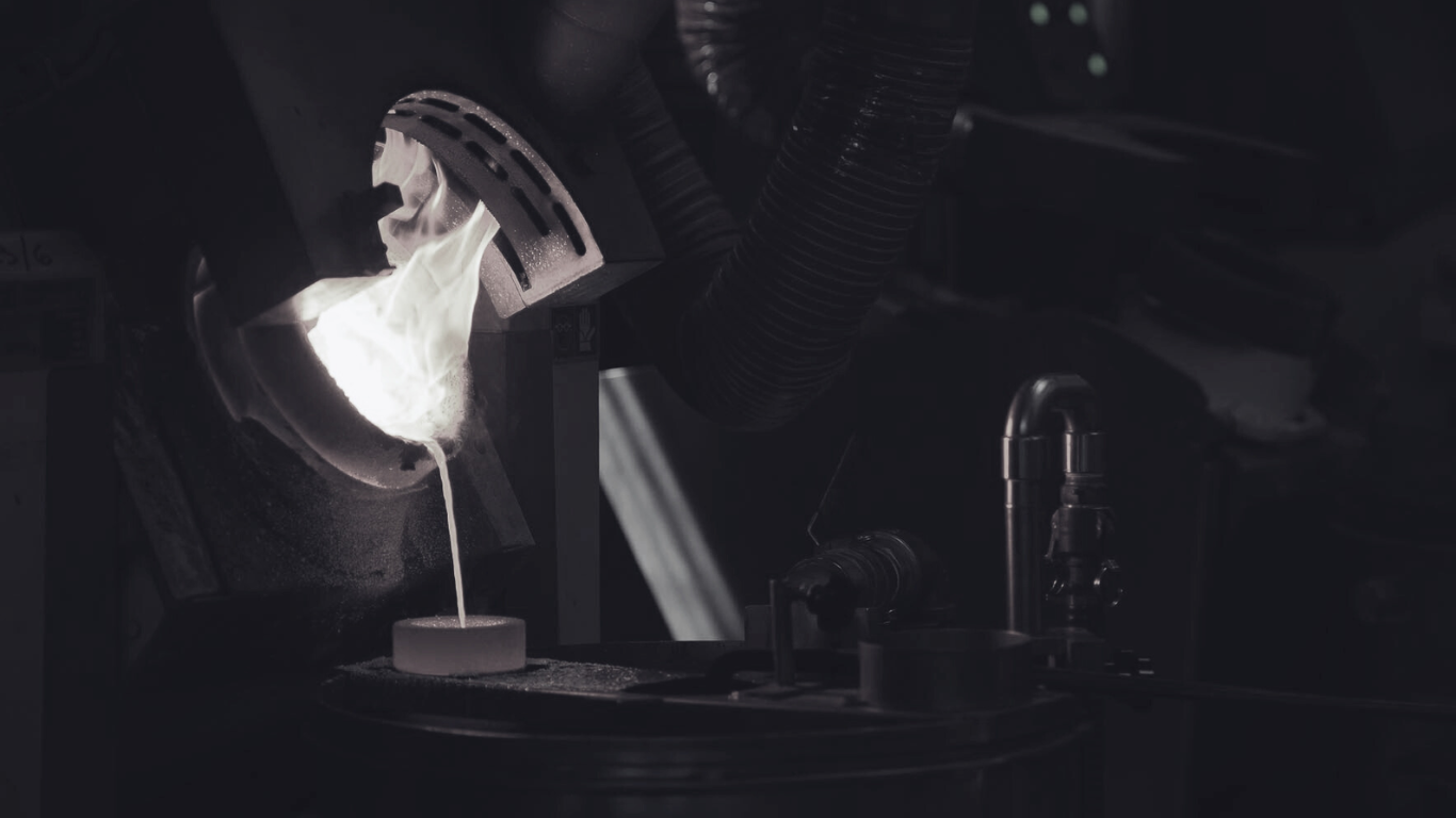 Pouring molten gold into a mold during the refining process at the Italpreziosi foundry.